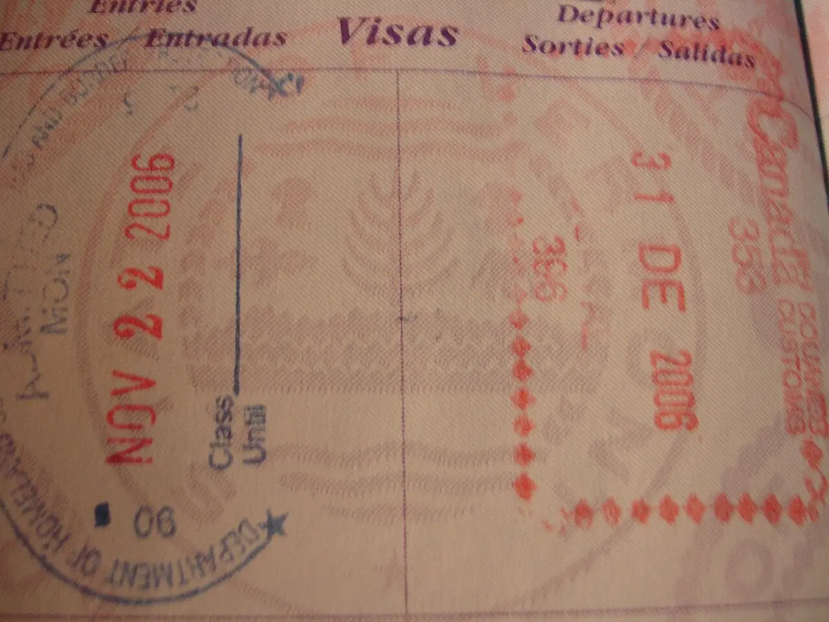 An open United States passport showing several inked entry and exit stamps