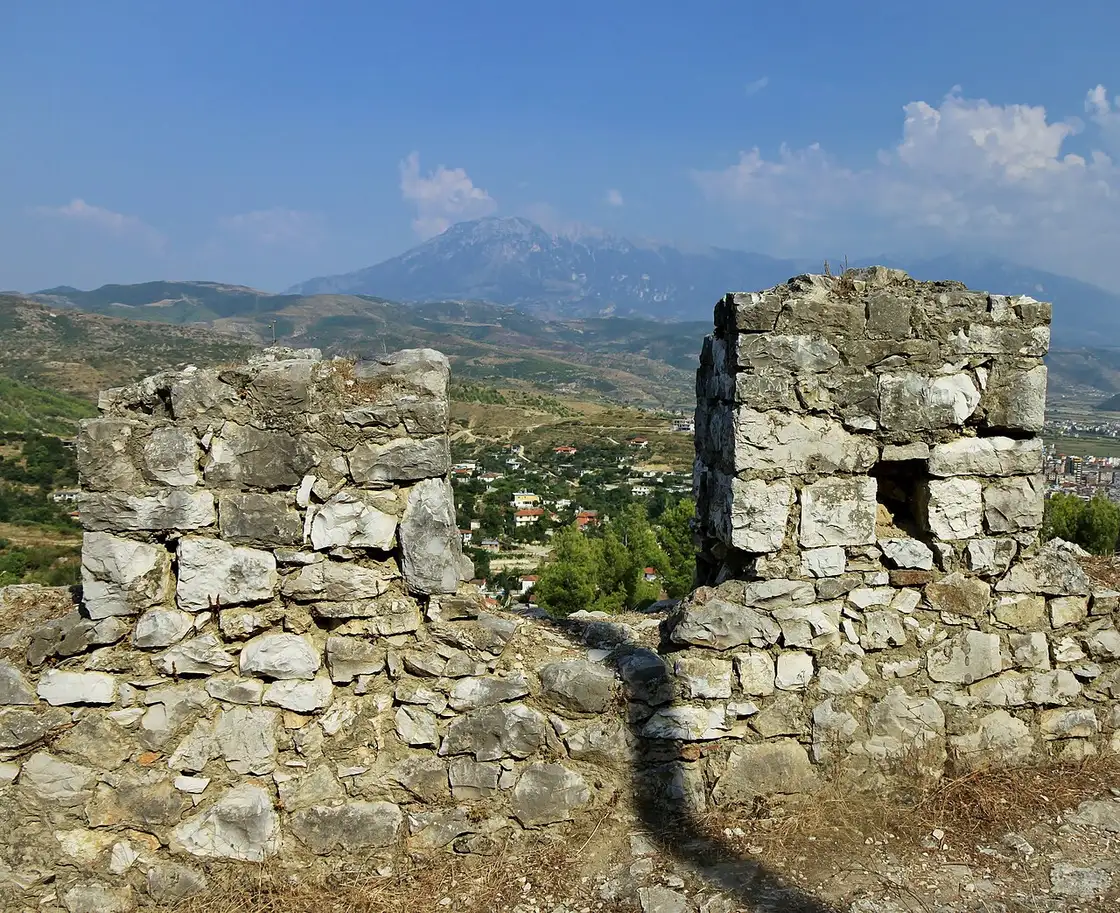 The stone walls and interior lanes of Berat Castle, still a lived-in quarter above the valley