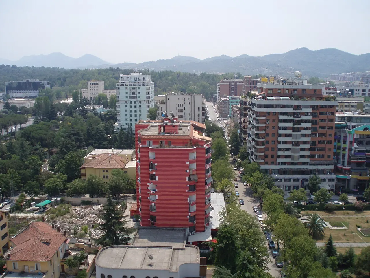 An aerial view over central Tirana from the Sky Tower, rooftops and boulevards spreading toward the hills