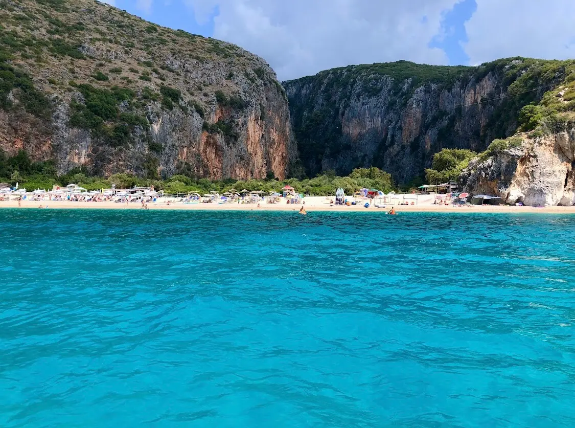 The turquoise water and limestone cliffs of Gjipe beach on the Albanian Riviera, seen from the sea
