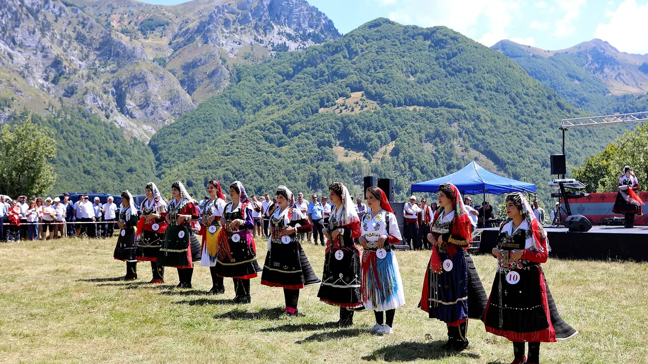 Women in traditional Kelmendi folk dress lined up for the Miss Bjeshka contest at the Logu i Bjeshkëve festival in the Albanian Alps