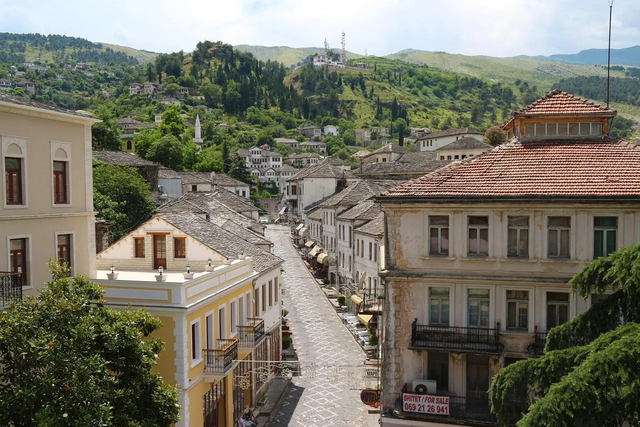 Grey slate roofs of Gjirokaster old town climbing the hillside under the castle