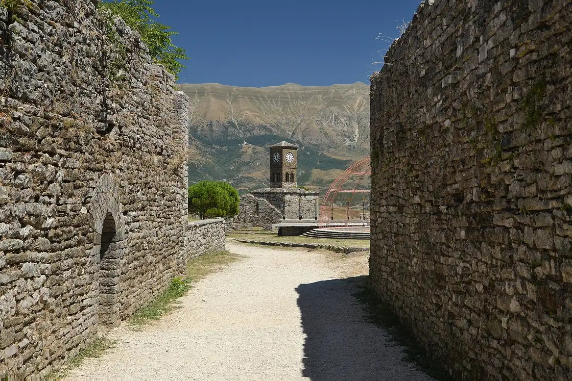 Stone walls and towers of Gjirokaster Castle overlooking the Drino valley