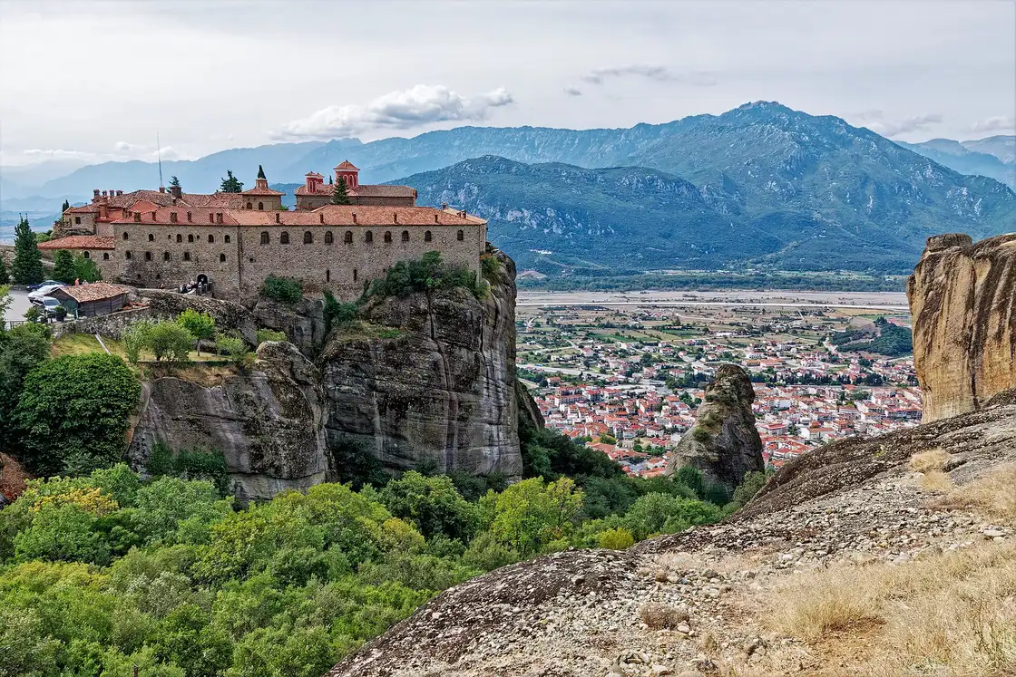 A Meteora monastery on a sheer rock pillar with more towers in the distance