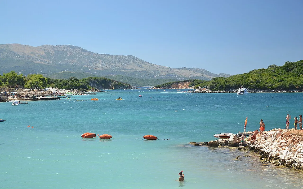 The clear turquoise sea and small coves of Ksamil under strong summer sun