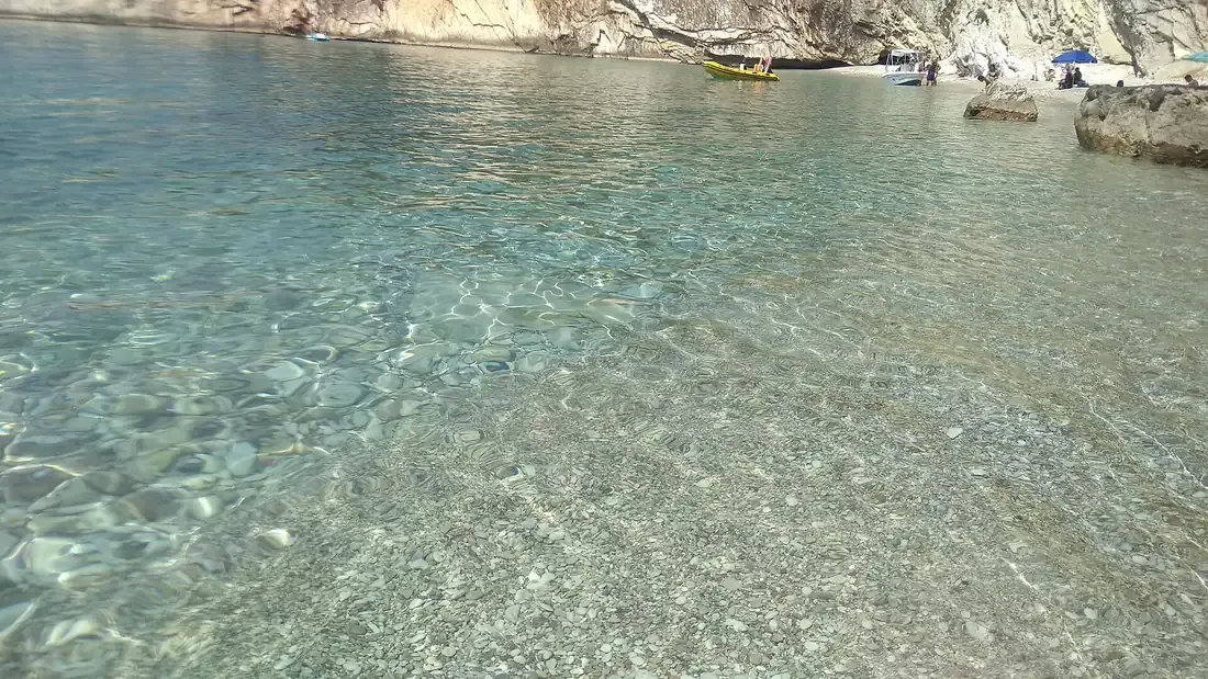 Filikuri cove near Himara with turquoise water against steep coastal cliffs