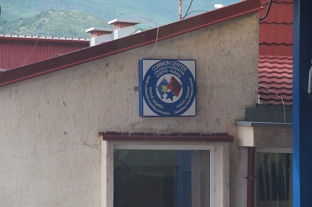 A sign for the joint Kosovo-Albania police cooperation centre at the Morina border crossing, with both flags