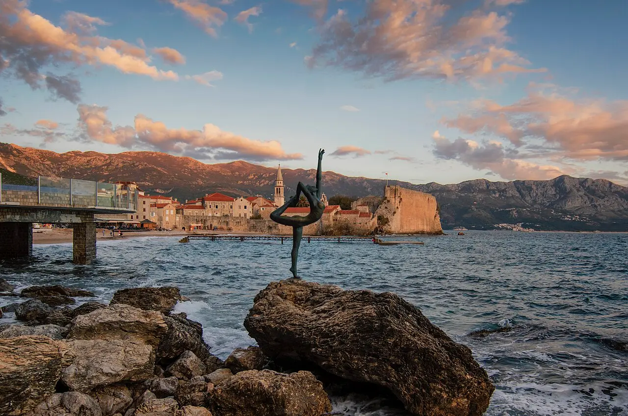 The walled old town of Budva on its peninsula with the Adriatic and mountains behind