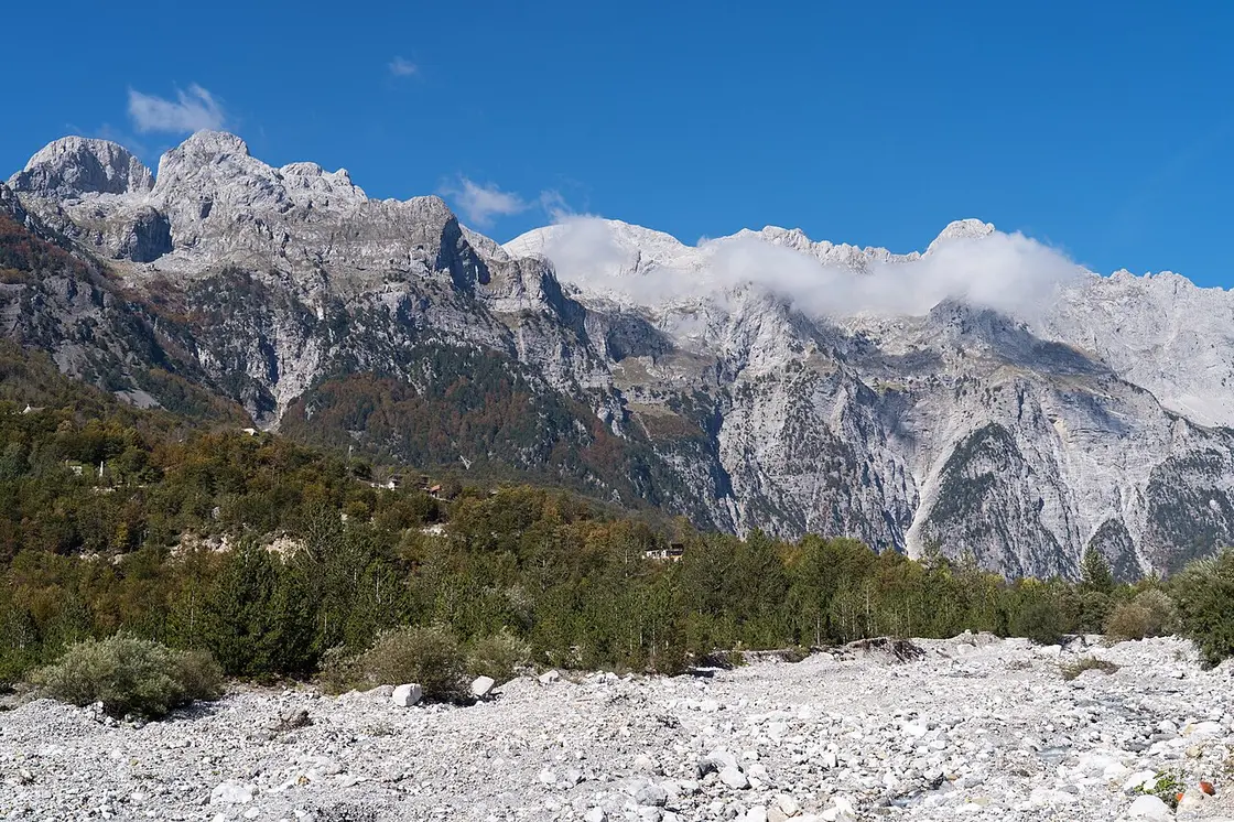 Remote mountains rising above the Theth valley in northern Albania under a clear sky