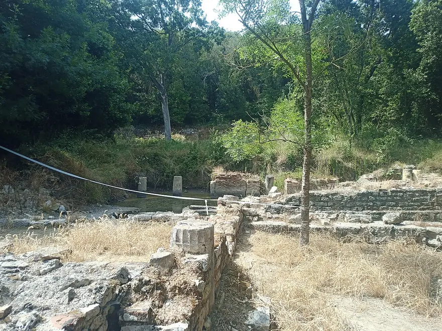 Stone ruins of the ancient forum at Butrint among trees