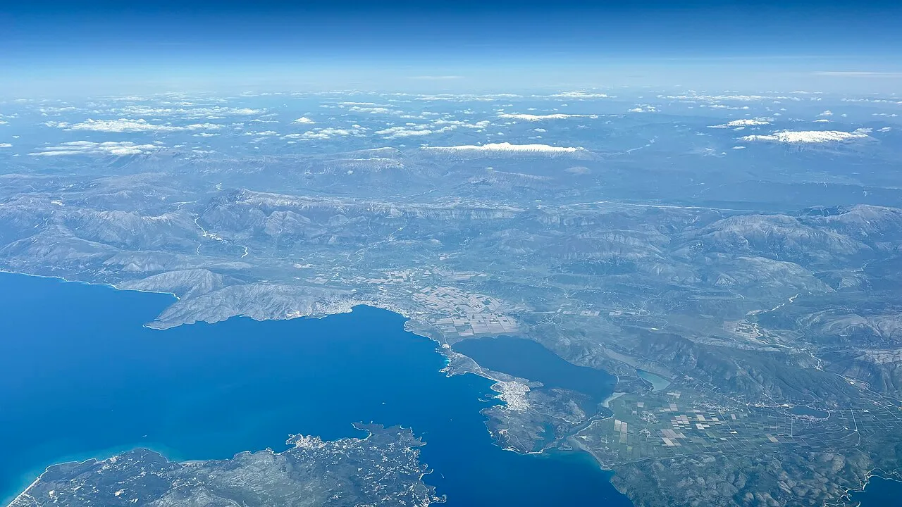 Aerial view of the turquoise water and small green islands of the Albanian coast near Ksamil