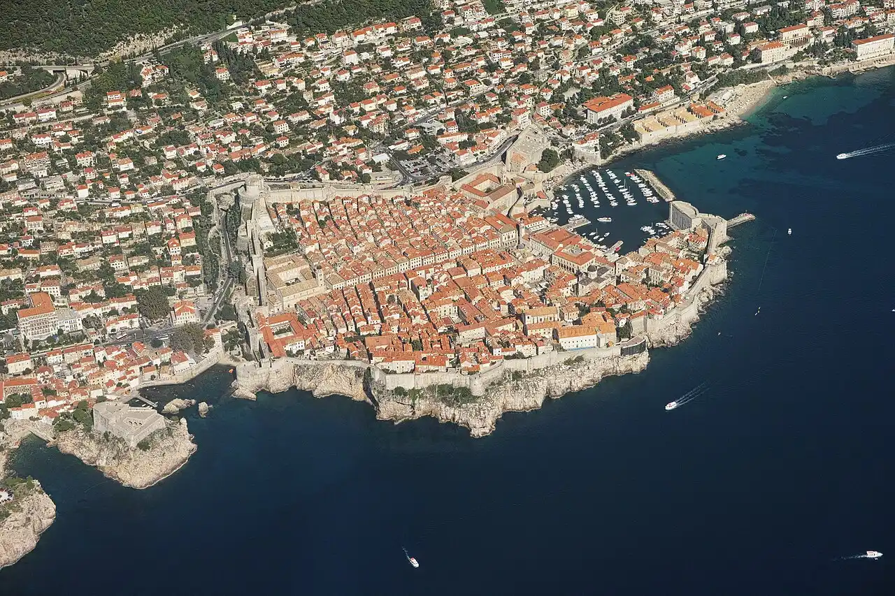 Aerial view of the walled Old Town of Dubrovnik in Croatia with its terracotta rooftops and city walls jutting into the Adriatic