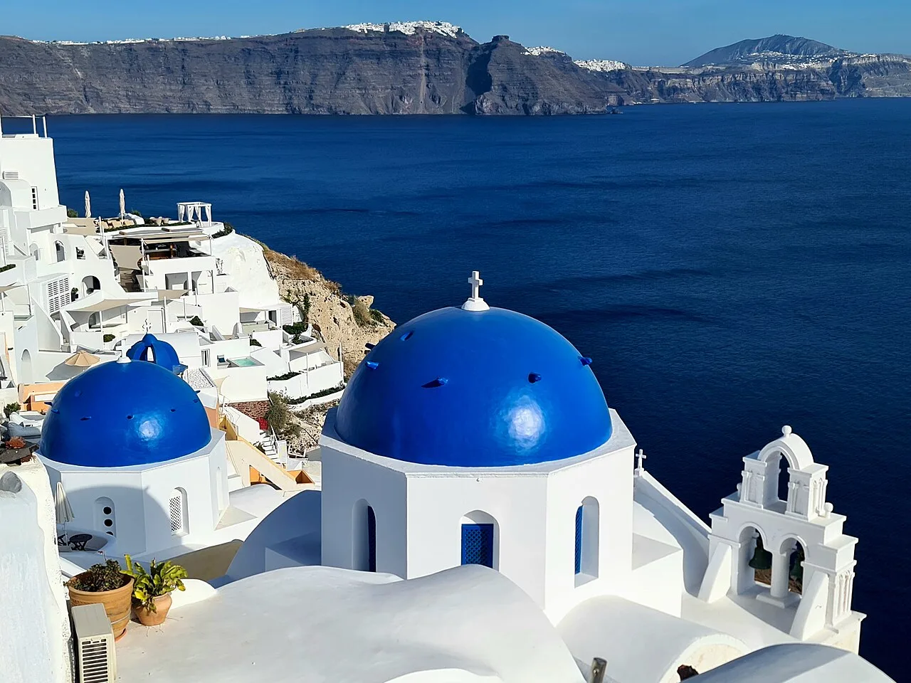The blue domes and whitewashed houses of Oia on Santorini above the caldera in Greece