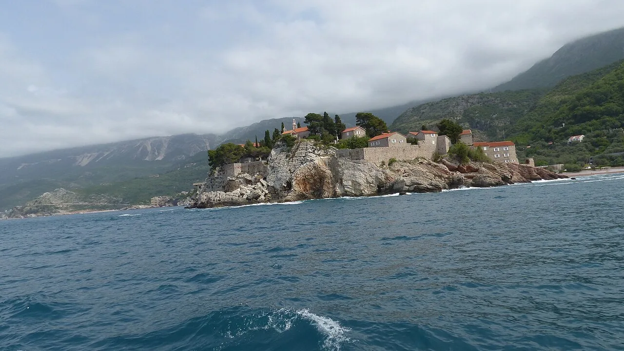 The fortified islet of Sveti Stefan linked to the Montenegrin coast by a narrow causeway, with the Adriatic around it