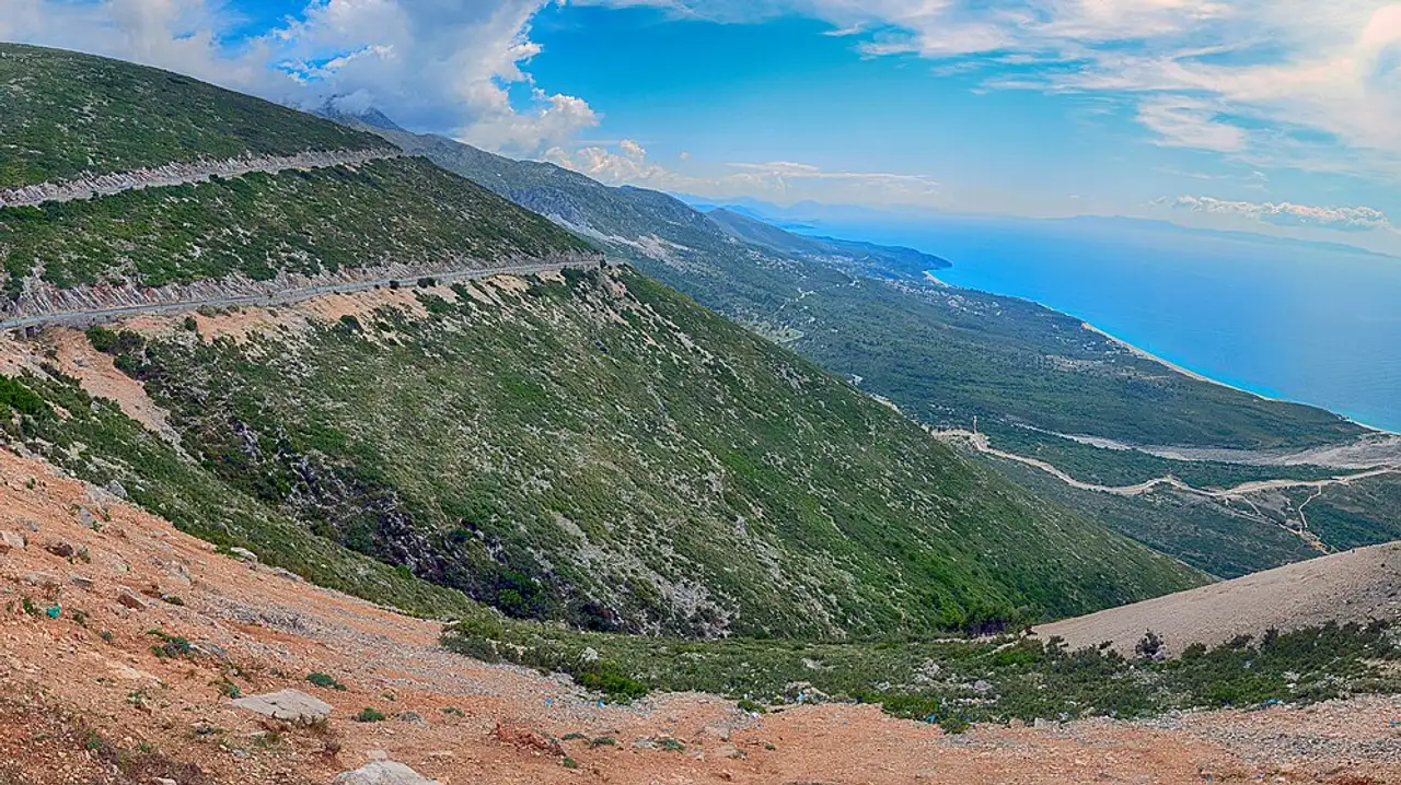 The Albanian Riviera seen from the Llogara Pass, with the coastal road winding down to the Ionian Sea
