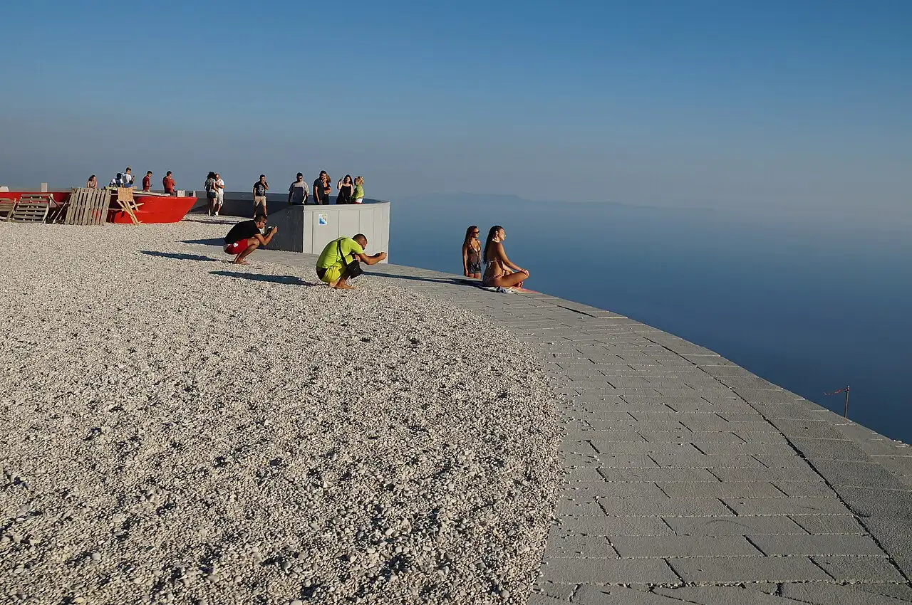 Visitors on the curved viewing platform at the Llogara Pass looking out over the Ionian Sea