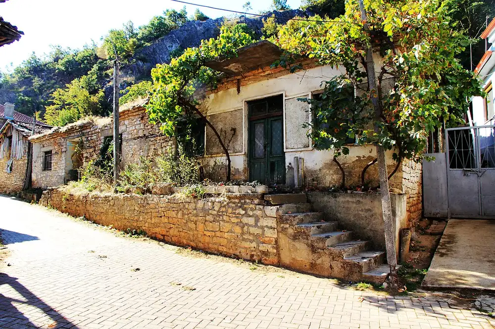 An old stone house in Lin with grapevines trained across the courtyard