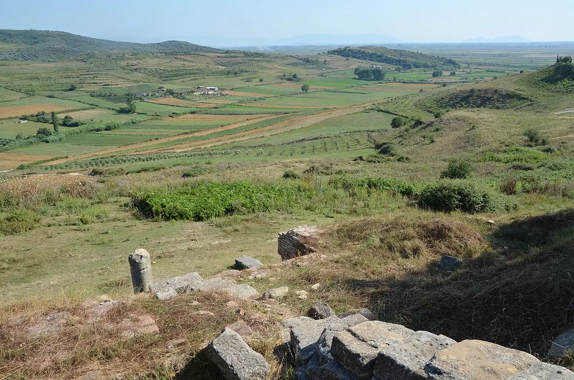 The Myzeqe plain of farmland and low hills seen from the hill of Apollonia, with a column stump in the foreground