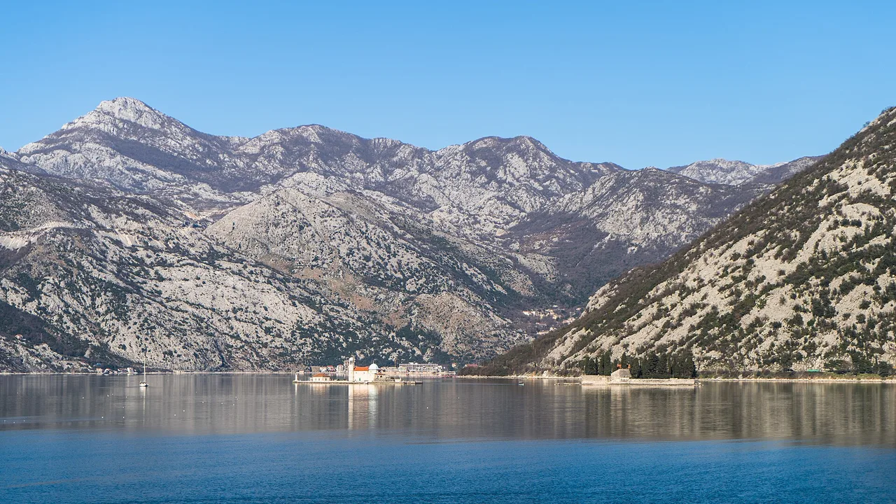 The Bay of Kotor seen from Lepetani, the still water hemmed in by steep mountains under a winter sky