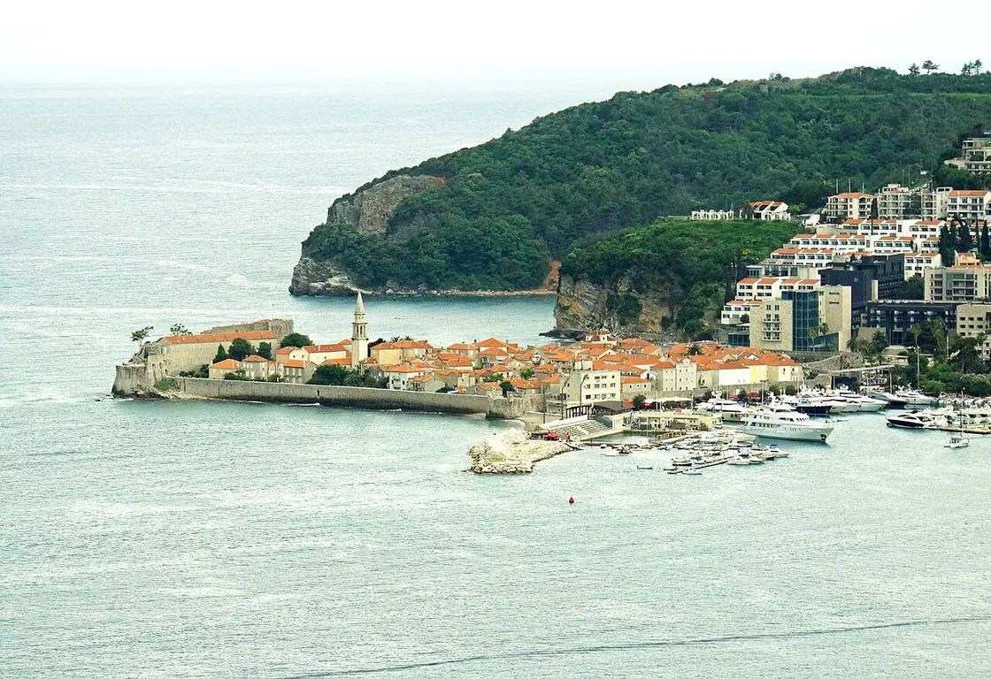 The walled old town of Budva on its small peninsula with the Adriatic and coastal hills behind