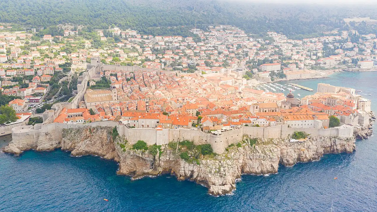 The city walls of Dubrovnik dropping straight into the deep blue Adriatic on the old town seafront