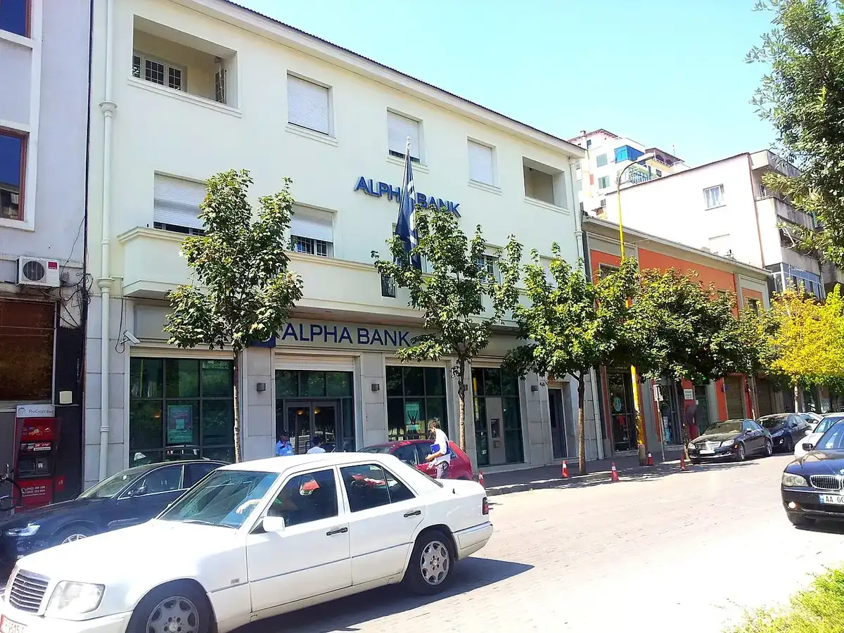 Exterior of a bank branch building on a street corner in Tirana