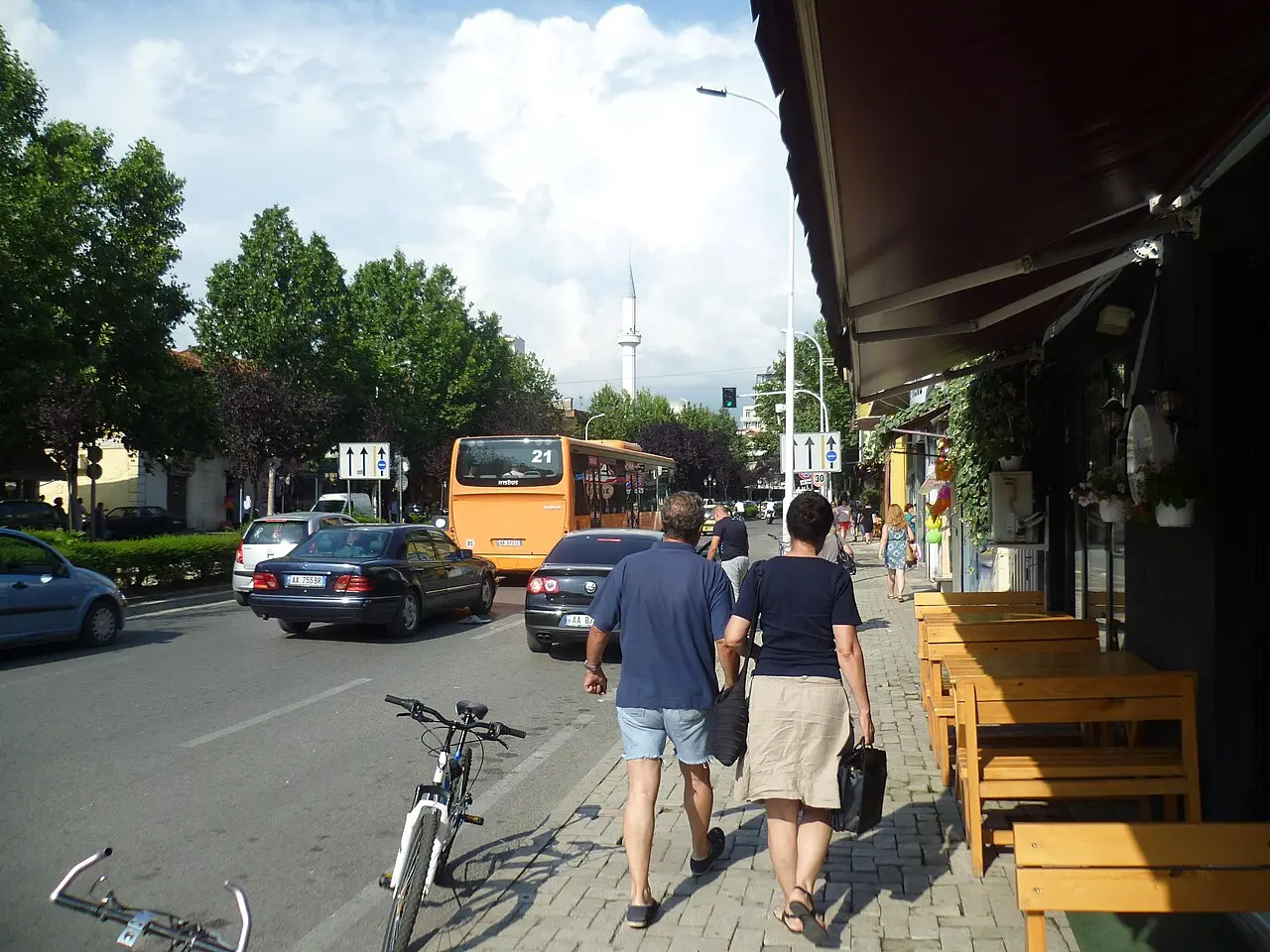 A street scene in Tirana with shops and pedestrians
