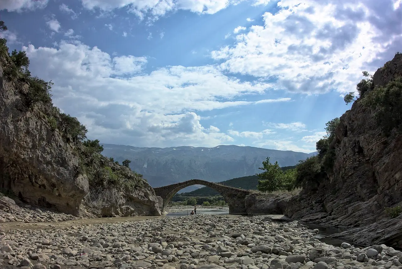 The Kadiu Bridge framed by the Lengarica gorge with the snow-streaked Nemercka range behind