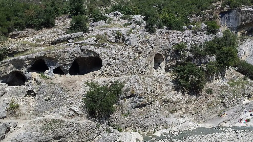 Old vaulted bathing chambers cut into the rock above the Lengarica river at Benje