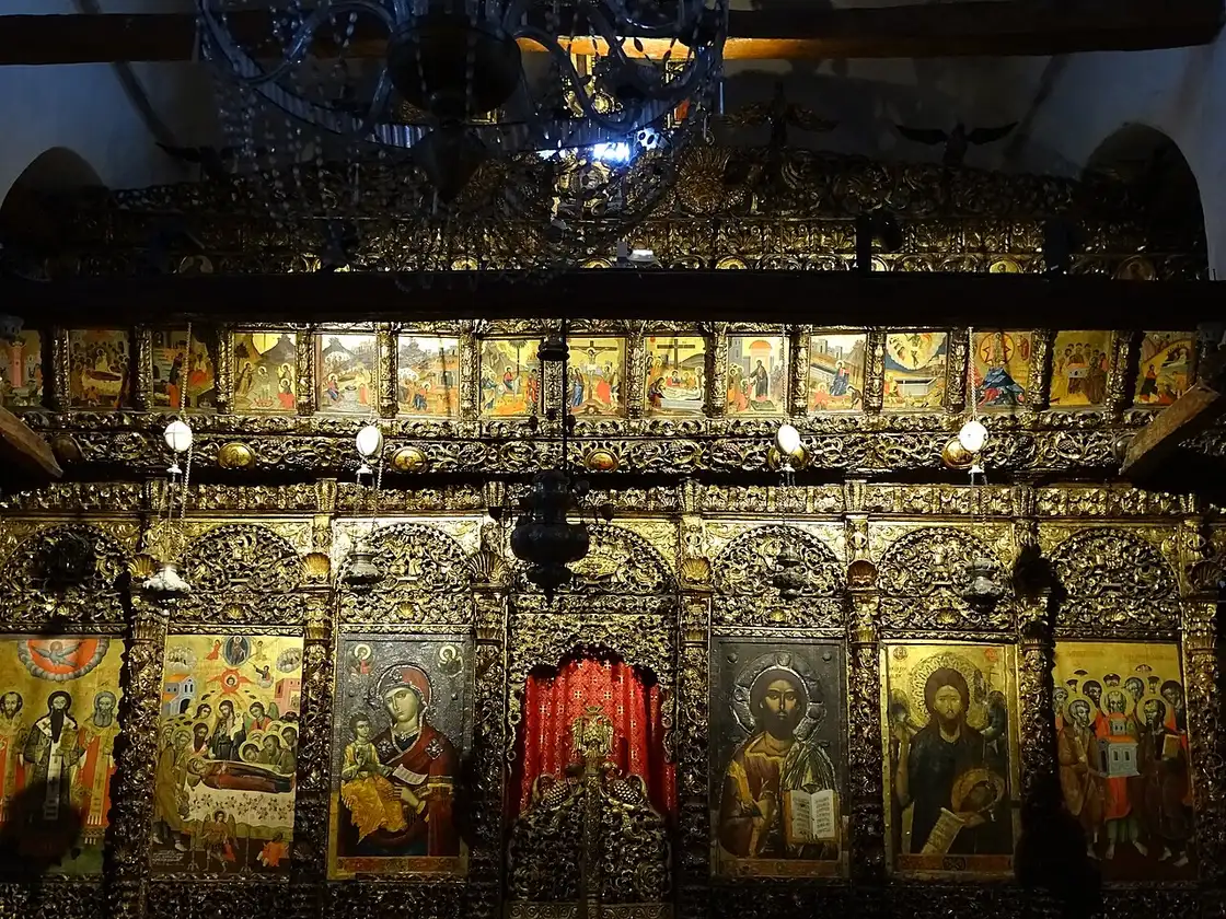The gilded carved iconostasis hung with icons inside the Onufri Museum church in Berat