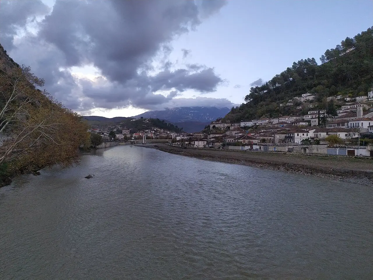 The Osum river flowing past the old town of Berat under a moody sky