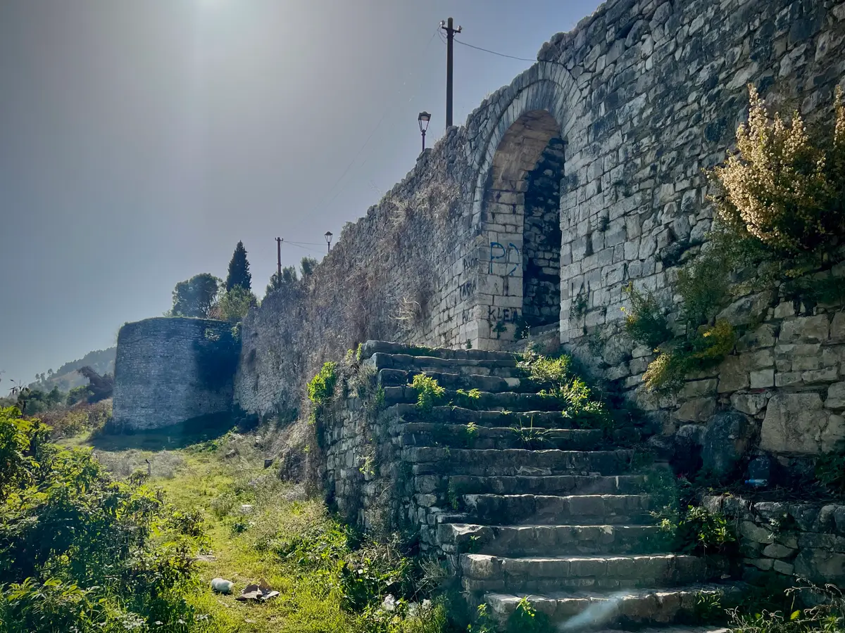Worn stone steps climbing along the inner side of the Berat Castle wall