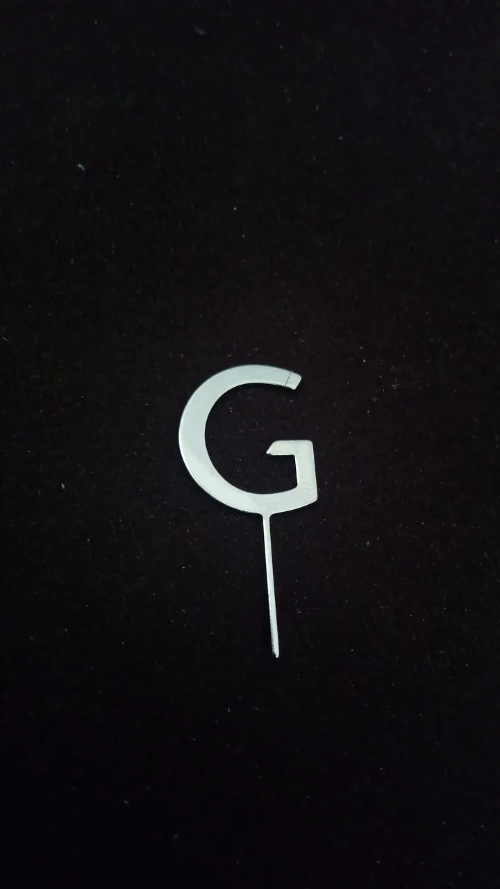 A SIM tray being ejected from a smartphone with the pin tool