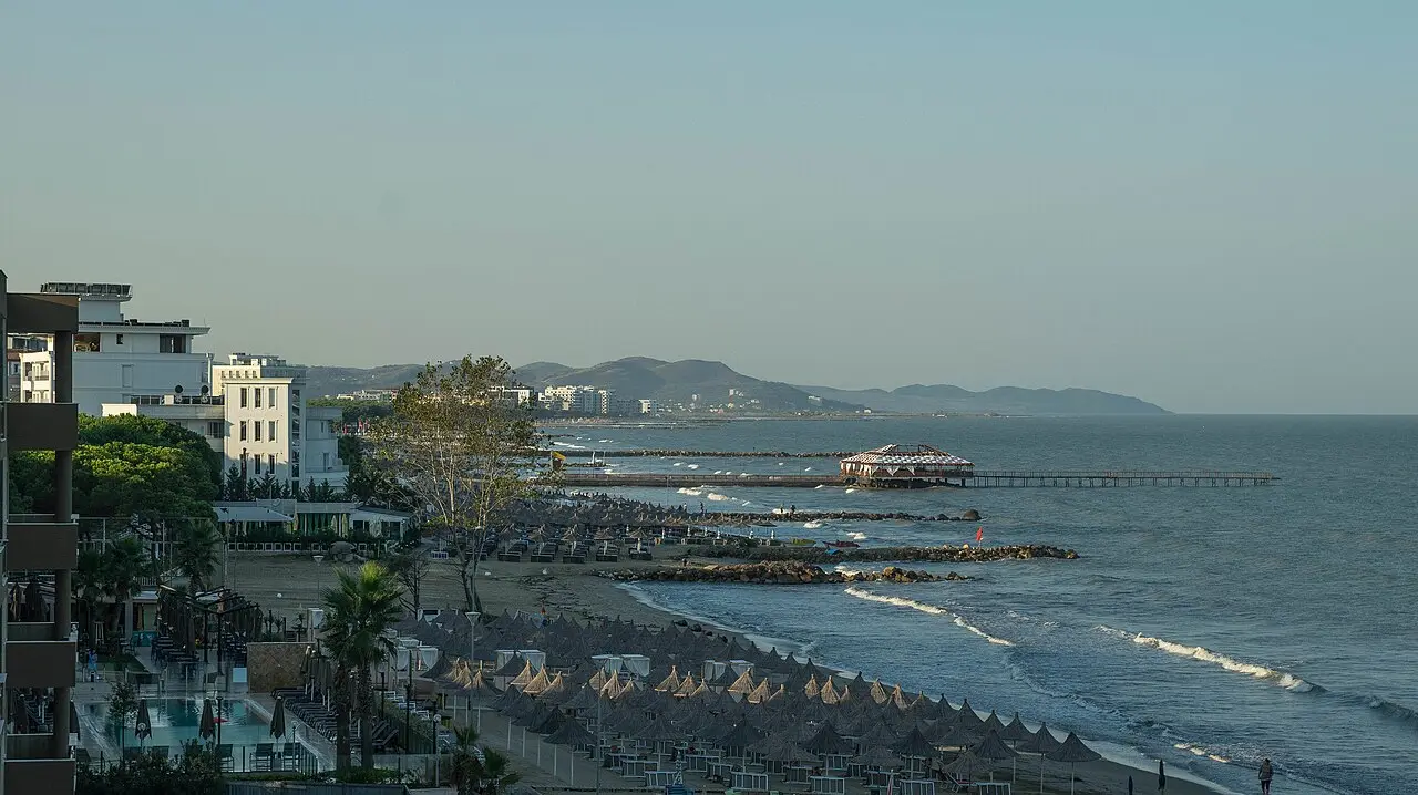 A wide sandy Adriatic beach with sunbeds and umbrellas on the Golem coast near Durres, Albania