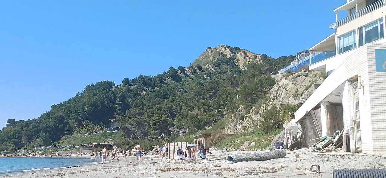 The rocky and sandy Currila beach on the edge of Durres with clear water and low cliffs