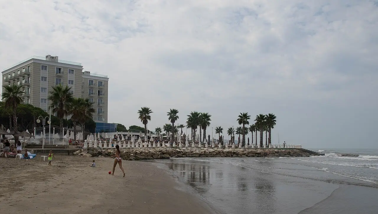 A resort hotel strip on the Golem coast near Durres with a wide sandy beach and rows of loungers