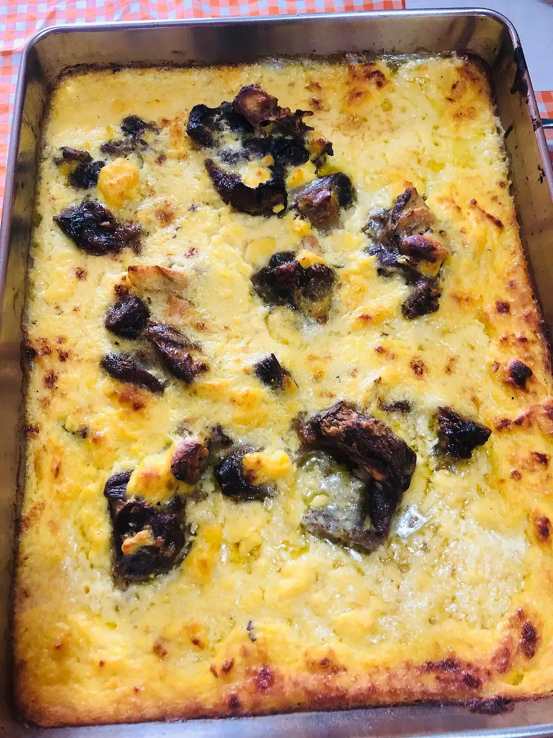 A dish of tavë kosi, baked lamb under a golden yogurt-and-egg crust, in a Tirana restaurant