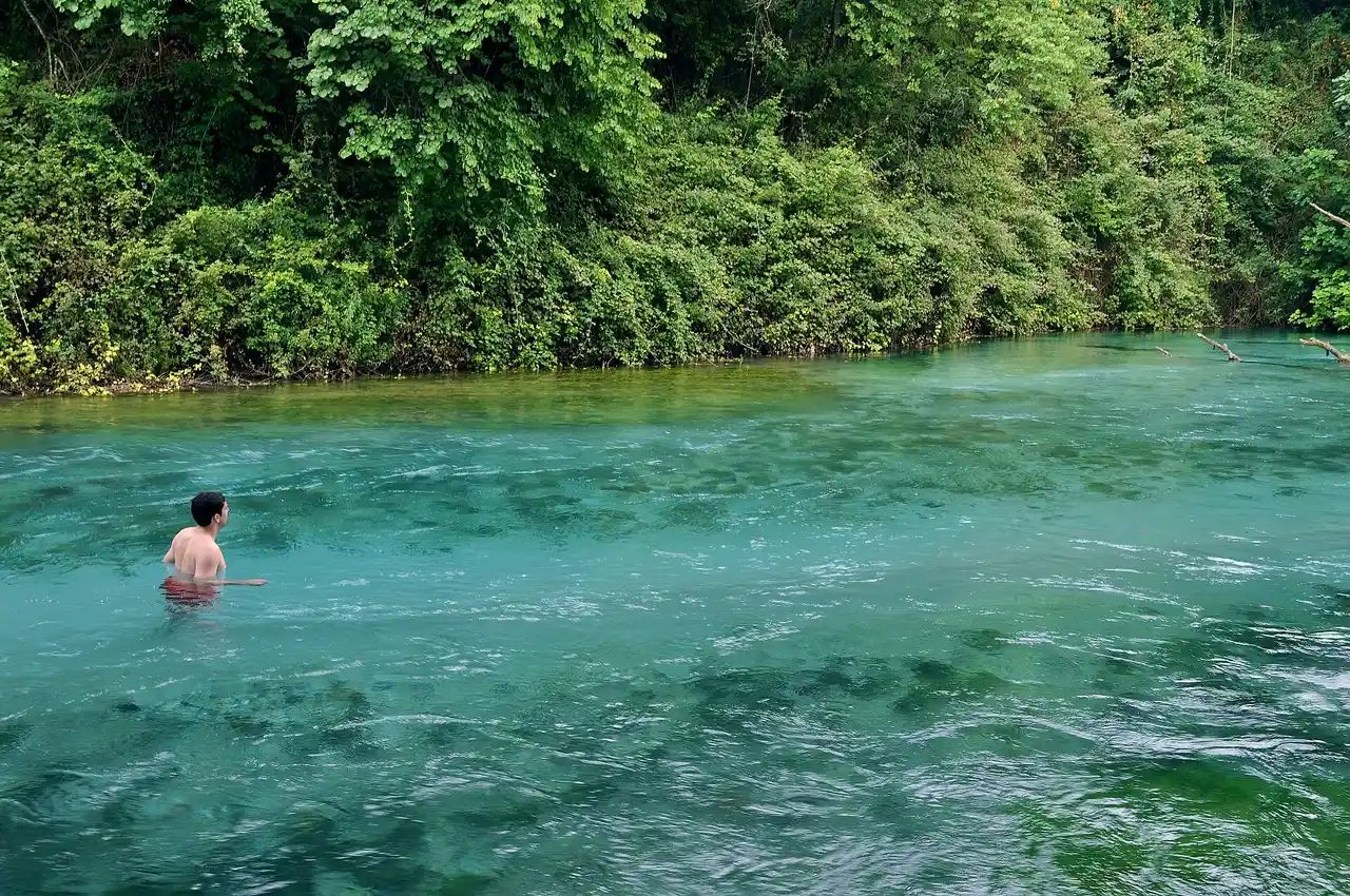 The Blue Eye spring seen from the bank with the Bistrica river flowing away