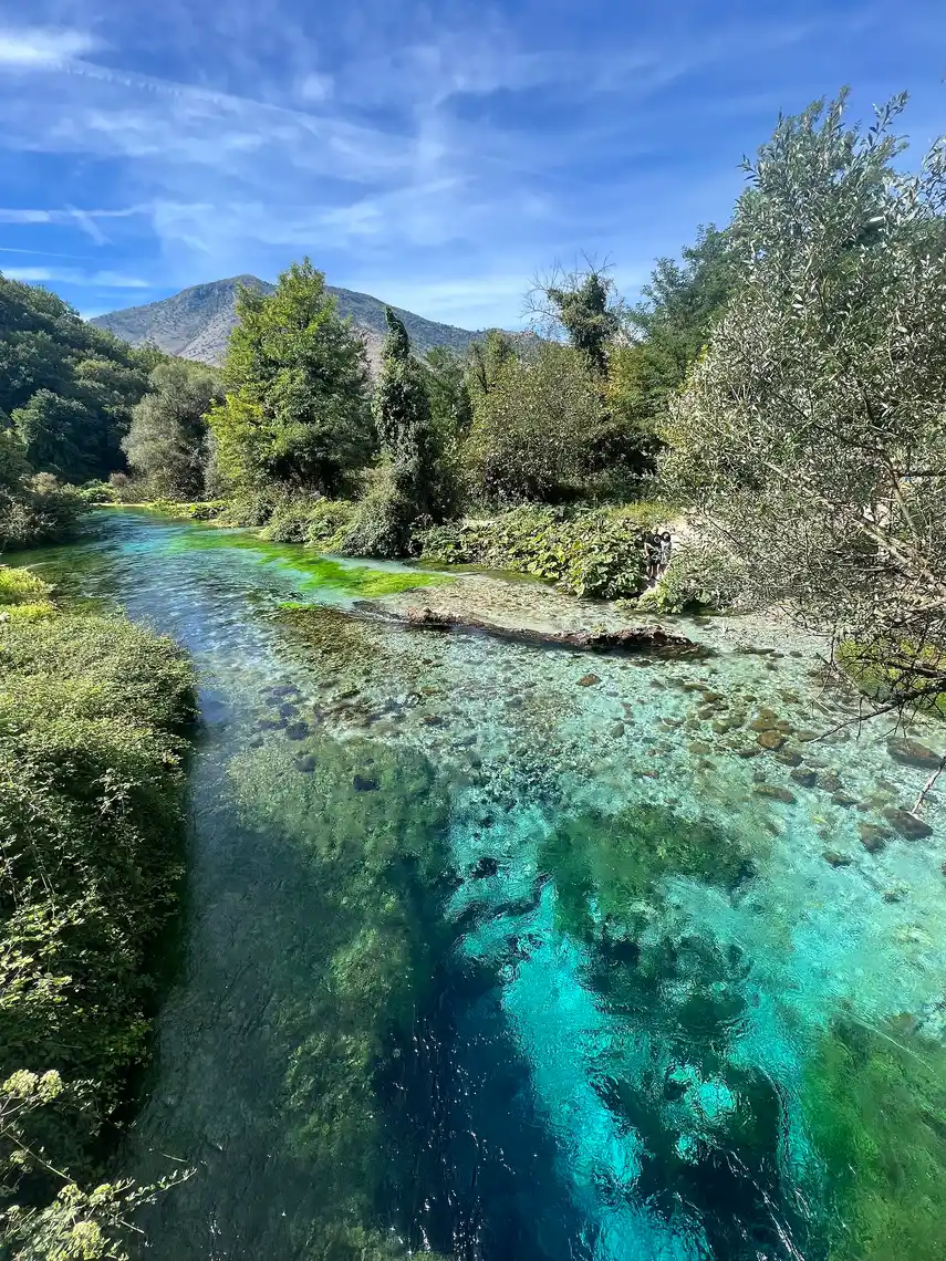 Close view of the Blue Eye's dark central shaft surrounded by clear turquoise water