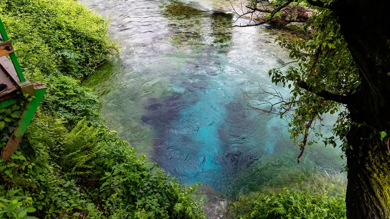 The Blue Eye pool and its wooden viewing platform among the trees