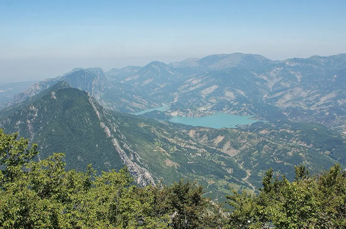 Close view of Bovilla Reservoir water against rocky, forested banks