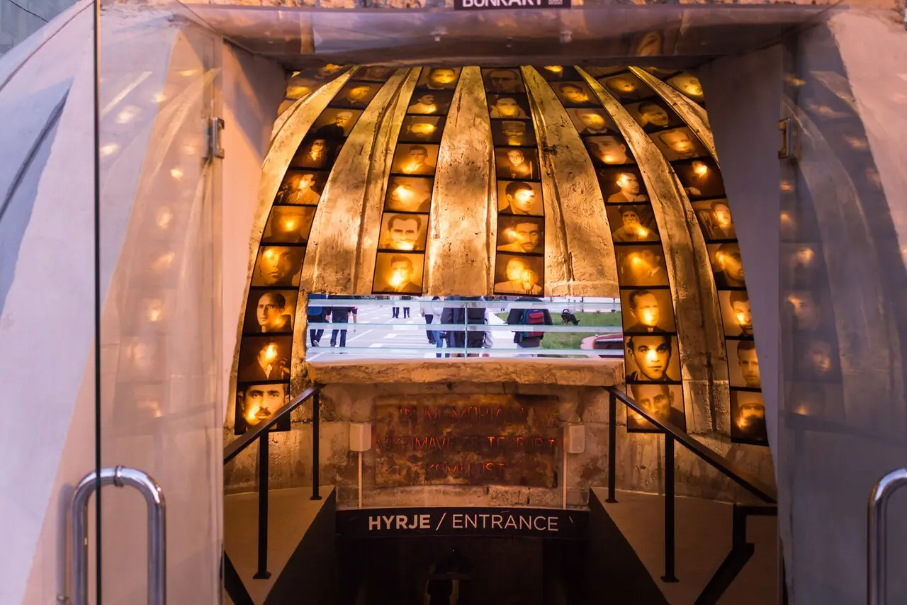 The domed entrance of Bunk'Art 2 lined with lit portraits of victims of communist repression