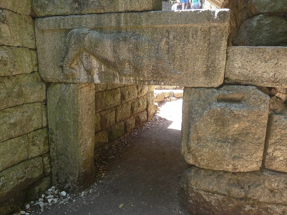 The Lion Gate at Butrint, a stone relief of a lion devouring a bull set above a low gateway