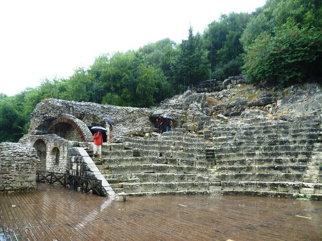 The curved stone seating of the ancient Greek and Roman theatre at Butrint