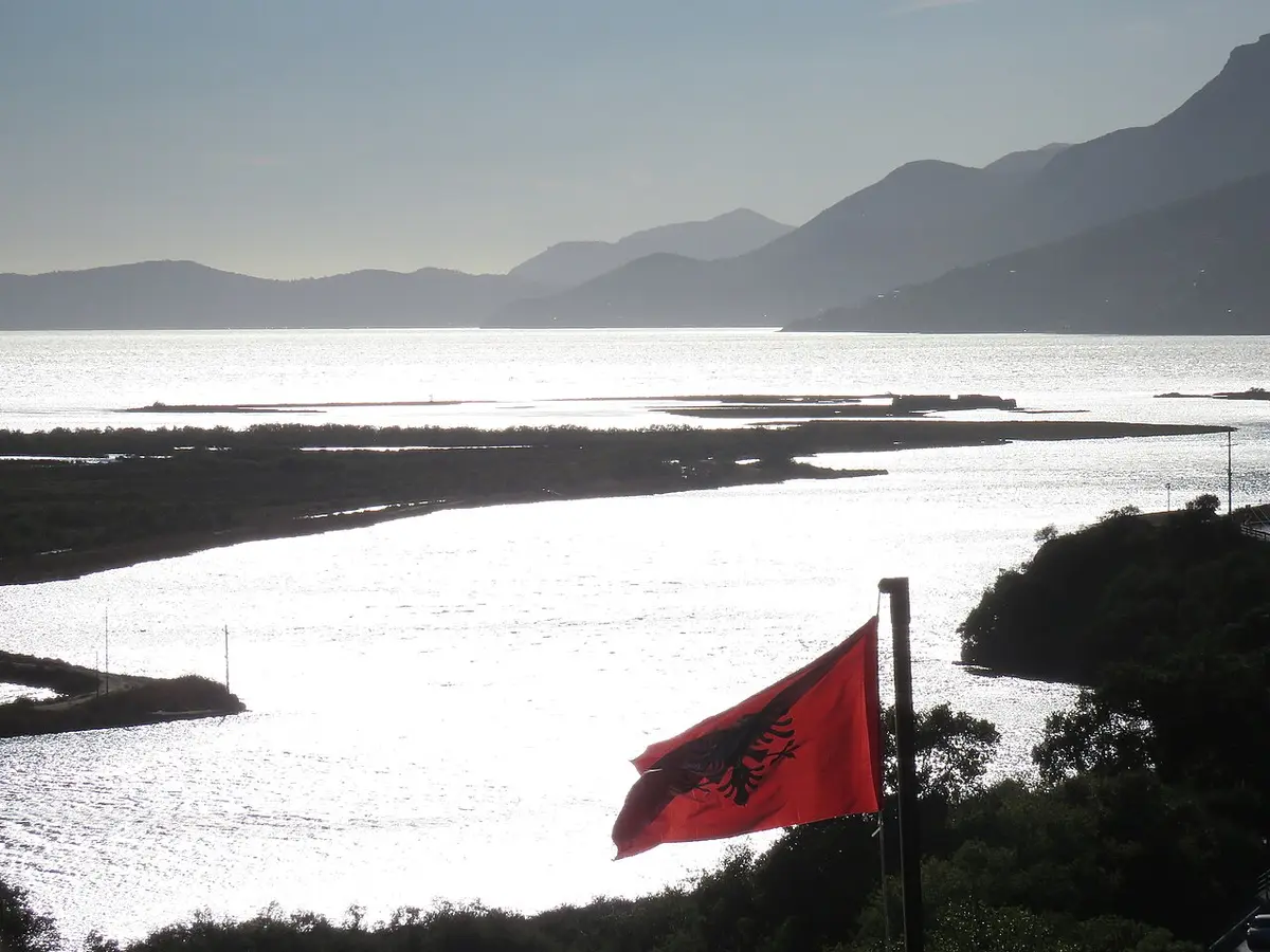 View from the Butrint fortress over the Vivari Channel and lagoon with an Albanian flag