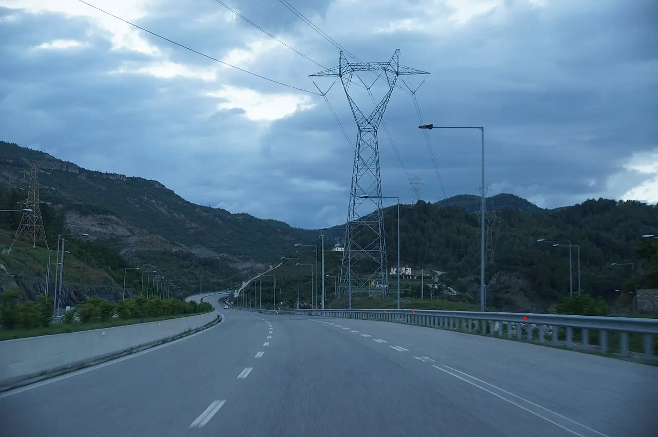 A dual-carriageway motorway in Albania with hills in the distance