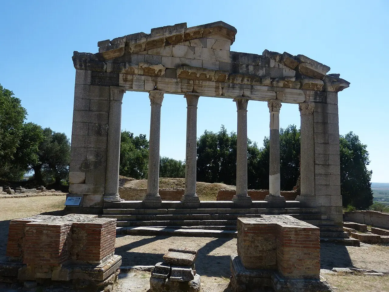 Re-erected column facade of the Monument of the Agonothetes at Apollonia among olive trees