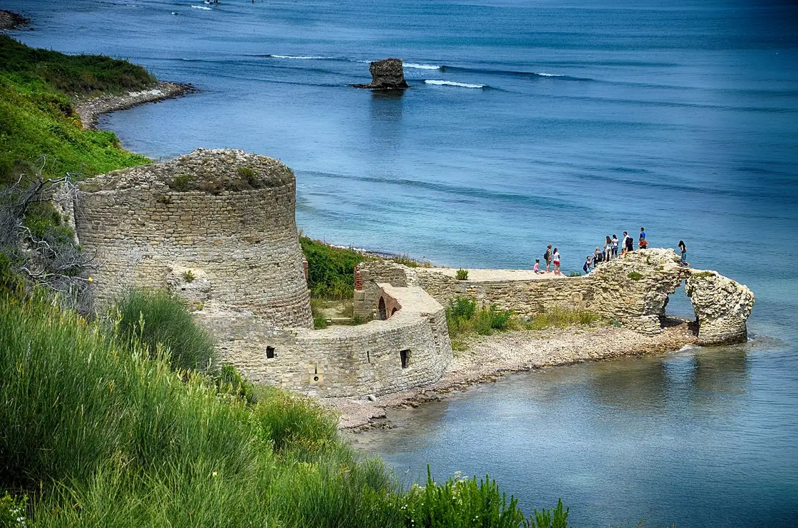 Ruined walls of Rodoni Castle on the rocky tip of Cape Rodon above the Adriatic