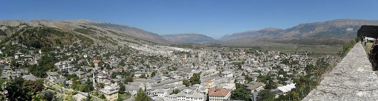 Wide panorama of Gjirokaster with its stone houses and castle above the Drino valley