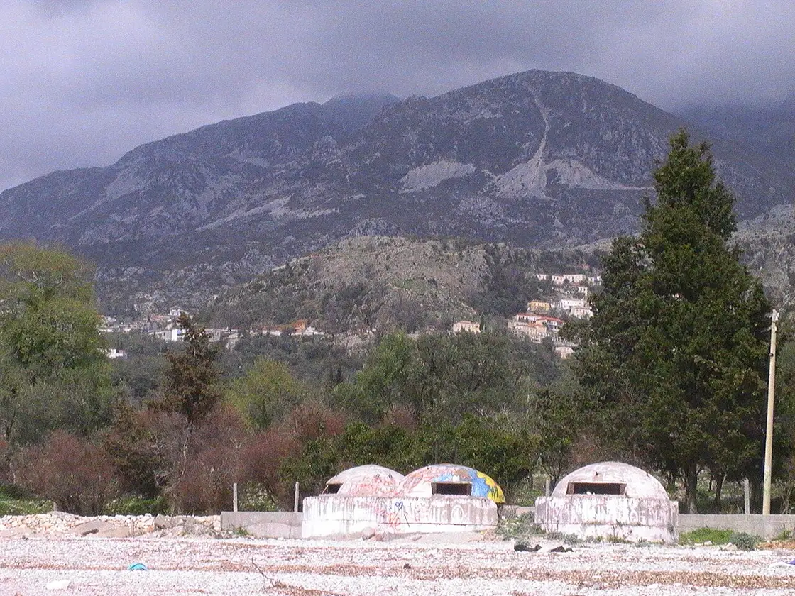 Concrete Cold War bunkers sitting on the scrubby slope above the sea at Dhermi